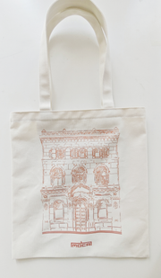 Natural-coloured tote bag with a red line drawing of MOCA's heritage building and the red MOCA wordmark.